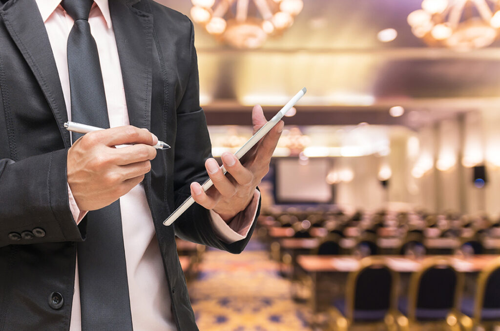 Man with tablet in meeting hall